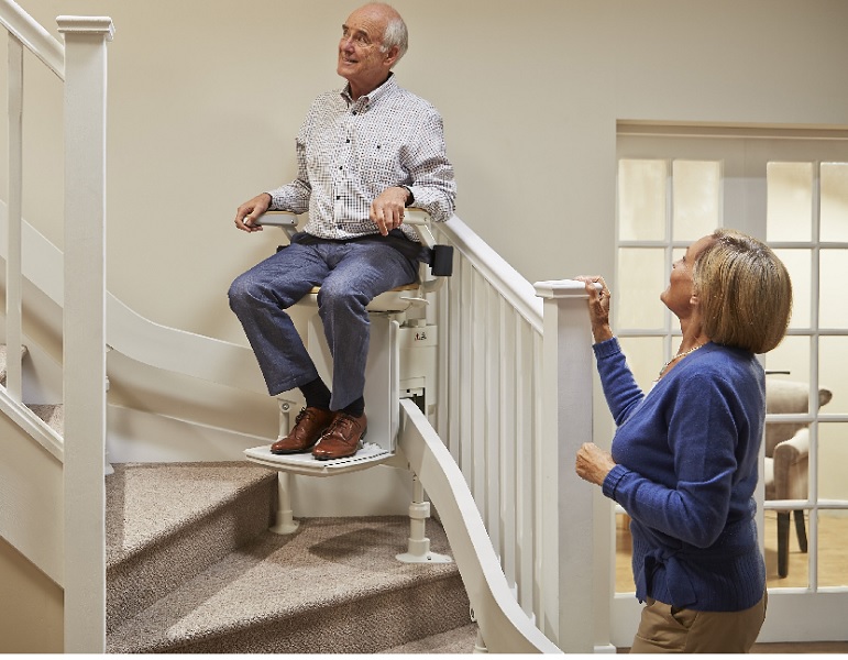 curved stairlift travelling up the stairs around corner