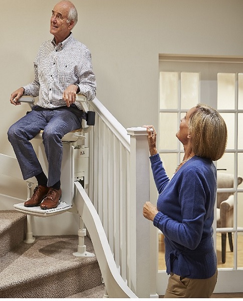 curved stairlift travelling up the stairs around corner and bends on the staircase